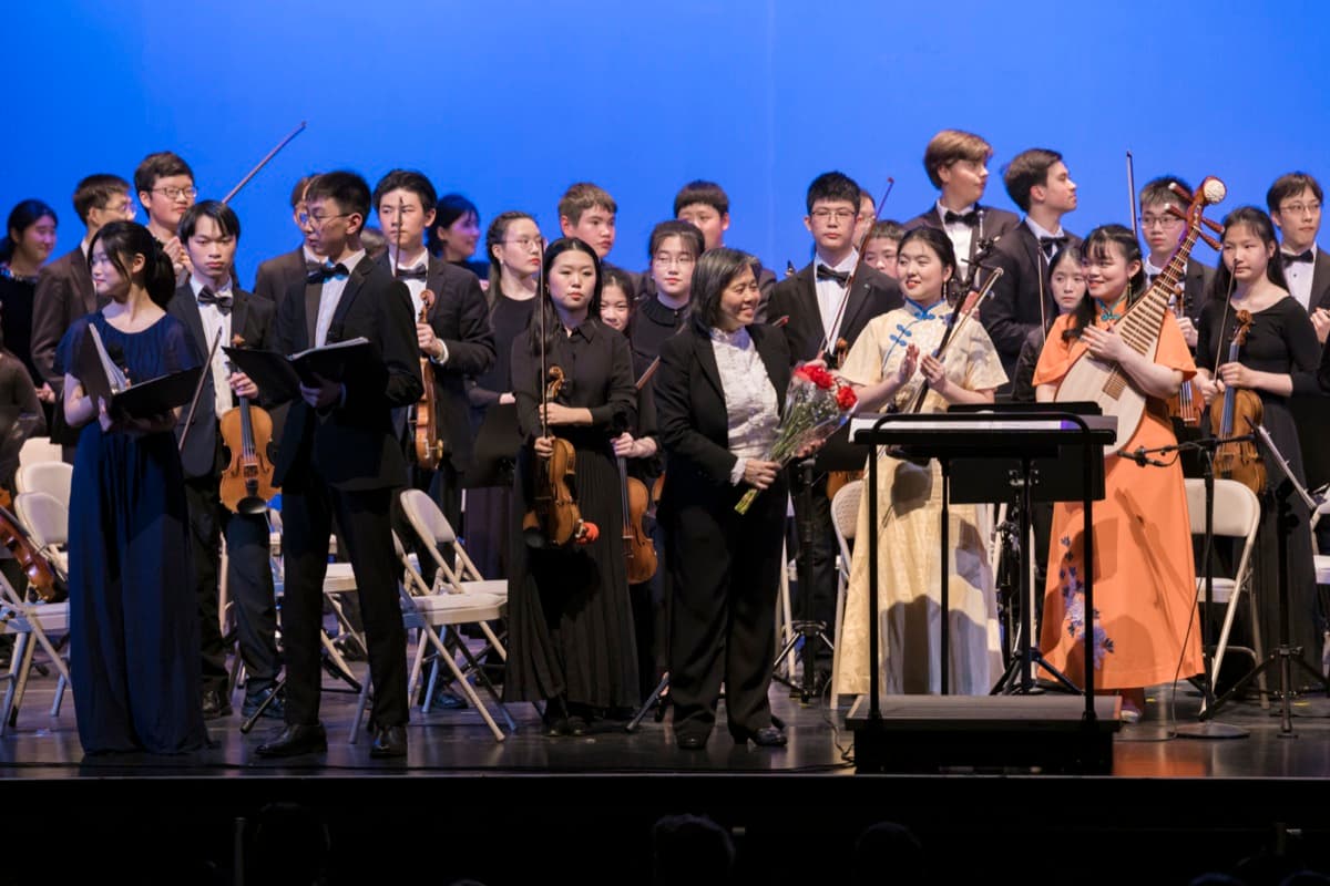 Orchestra members taking a bow after performance